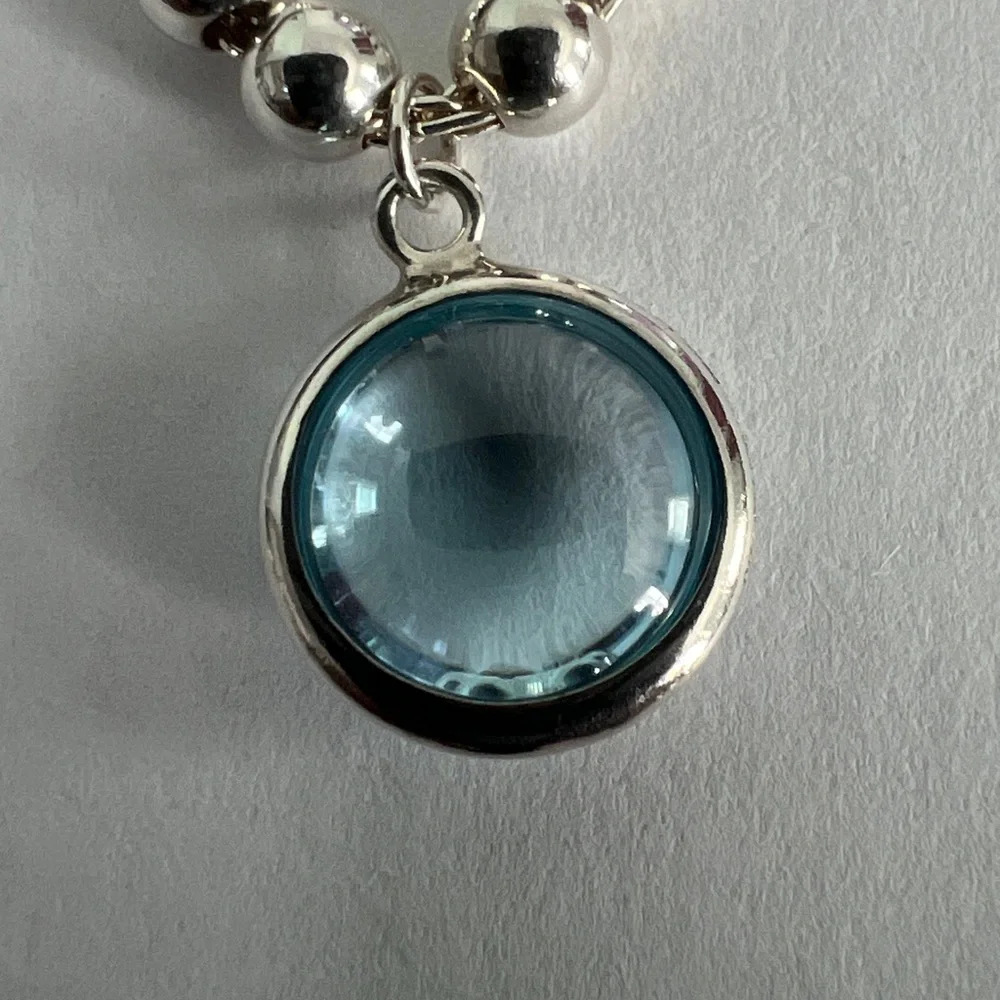 Elegant Silver Beaded Bracelet with Blue Charm